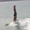 Next: Surfer doing headstand