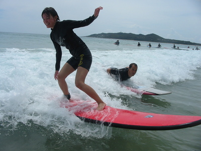 Photo: Celine and Ger surfing