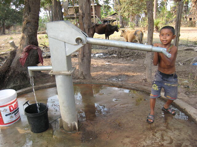 Boy pumping water