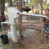 Next: Boy pumping water