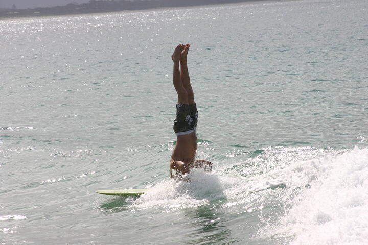 Surfer doing headstand