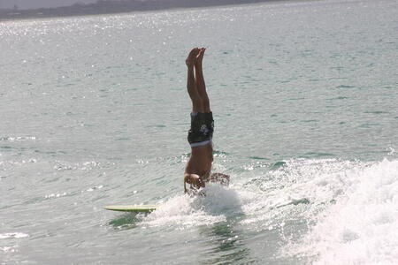 Photo: Surfer doing headstand