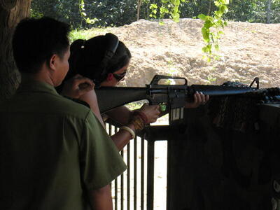 Photo: Girl firing machine gun