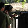 Photo: Girl firing machine gun